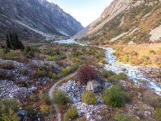 A mountain river, a stream meanders among the slopes of the mountain. Summer landscape, meadow and...