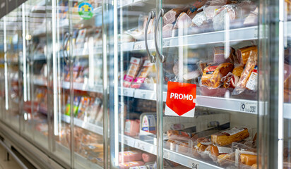 Promo sign at a commercial refrigerator in a supermarket