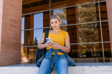 University student using smartphone on campus