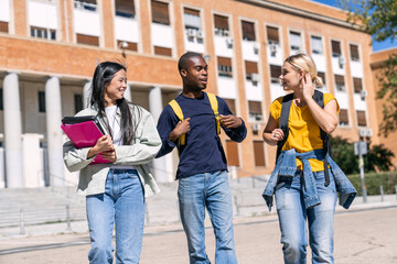 Obraz premium Multiethnic students walking and talking outside university