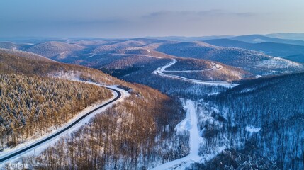 Winding Winter Road Through Snowy Mountain Forest Landscape