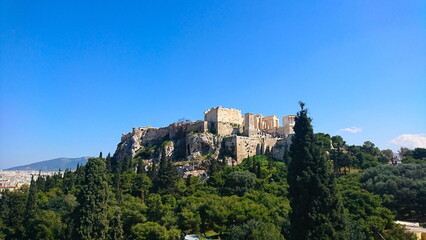 Athens, Greece - 29.3.2018: Propylaea, Monument of Agrippa, and Temple of Athena Nike on the Acropolis hill under a clear blue sky in the summer before the pandemic, view from Areopagus Hill