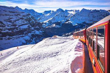 Alps train descending down from Jungfraujoch peak to Wengen, idyllic alpine landscape