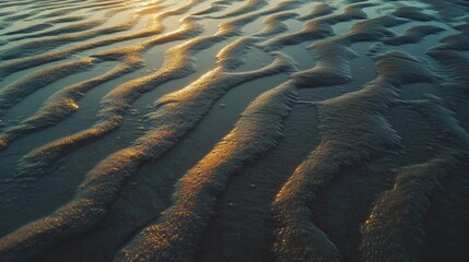 Soft, rolling waves forming intricate patterns on a serene beach at golden hour, creating a tranquil scene