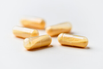 Coenzyme Q10 capsules. Antioxidants. Concept for a healthy dietary supplementation. Bright paper background. Soft focus. Close up. Copy space.