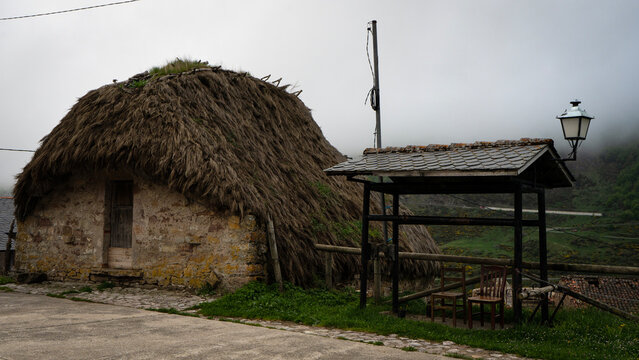 Traditional thatched roof h&oacute;rreo in asturias, spain, on a foggy day
