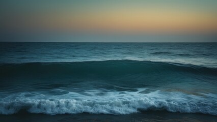 Obraz premium A serene view of the calm ocean at dusk, featuring gentle waves under a pastel sky. The peaceful atmosphere invites relaxation and contemplation
