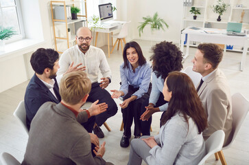 Young addict people talking on group therapy meeting, sitting in circle, discussing addiction,...