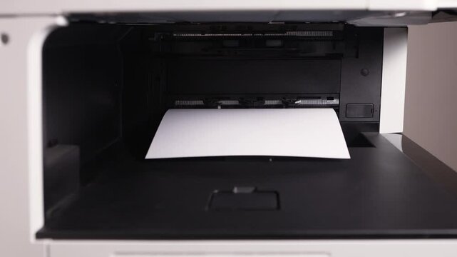 A3 paper document comes out of the printer after printing
