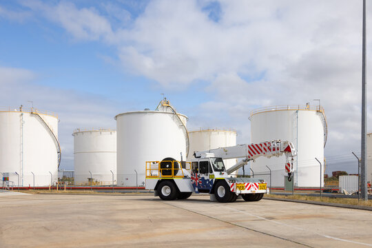 pick and carry crane truck parked on concrete ground of industrial site