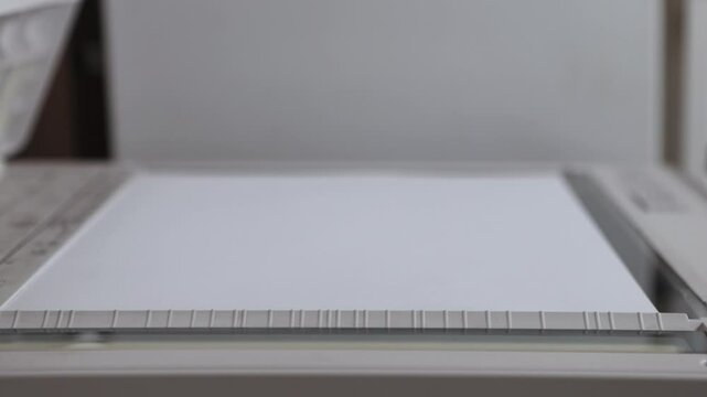 An office scanner performs the process of scanning an A3 document. Scanning paper to the MFP