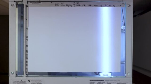 An office scanner performs the process of scanning an A3 document. Scanning paper to the MFP