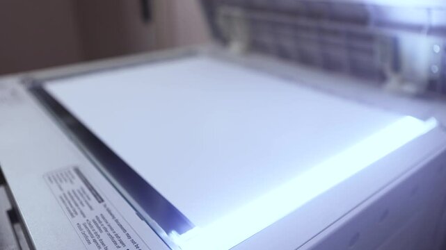 An office scanner performs the process of scanning an A3 document. Scanning paper to the MFP