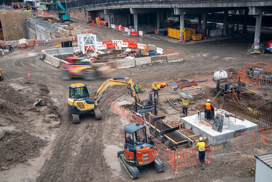 Construction site with machinery and workers in high-vis