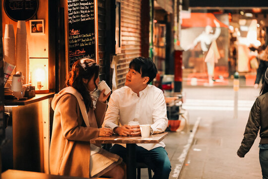 Couple enjoying coffee together at alfresco table at small coffee shop in Melbourne laneway