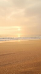 Obraz premium Warm golden sand stretches along the shoreline as sunlight casts a serene glow on the vast expanse of water, light, sea, beach
