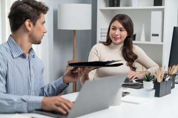 Smiling beautiful woman hand over folder report analysis paper to smart manager on desk at side view at modern office in morning. Finished research project for business proposal on time. Postulate.