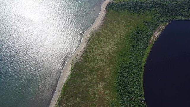 High altitude aerial view of Queue of Mal Bay and the Macgregors Mal Bay marshes stretching along the Gulf of St. Lawrence coastline on Miscou Island, New Brunswick, Canada.