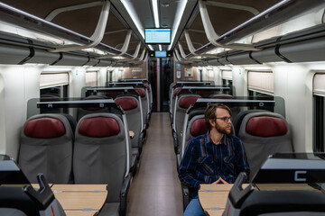 Fototapeta premium Passenger Traveling Alone in a Modern Train