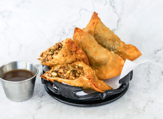 Chicken Samosa with chutney served in tray isolated on grey background side view of Pakistani and Indian food