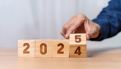 Naklejka premium New project growth concept in 2025, Preparation for happy new year , Hand of man flip wooden
