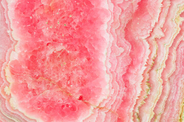 High-resolution image of rhodochrosite mineral specimen stone rock shows the intricate patterns and...
