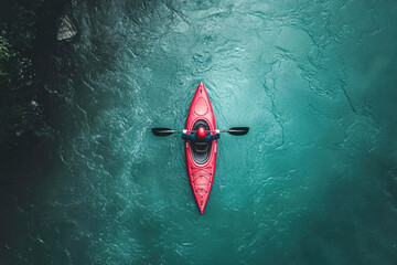 A person in a red kayak is floating on a body of water