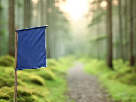 A blue flag is hanging from a wooden pole in a forest
