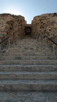 View of the stone steps leading to the main palace entrance at Herodium, Israel. A stunning blend of ancient architecture and history in the heart of the Judean desert.