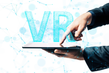 Hands holding a tablet with glowing VR text, surrounded by digital connections, on a clean white background. Concept of virtual reality