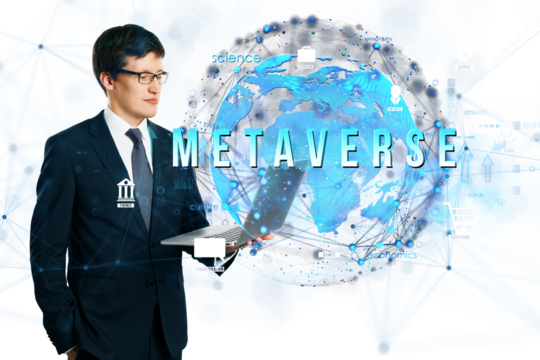 Businessman in suit holding laptop with digital holographic globe and Metaverse text, on white background, representing virtual technology