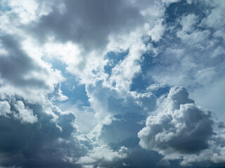 Fototapeta premium Sunlit clouds drift across the sky.