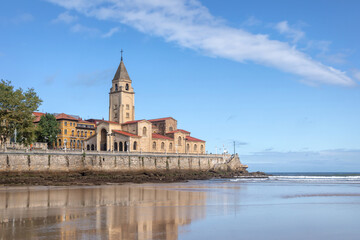 Fototapeta premium Iglesia de San Pedro - restored 15th-century Catholic church with a bell tower in a seaside old-town in Gijon, Asturias, Spain