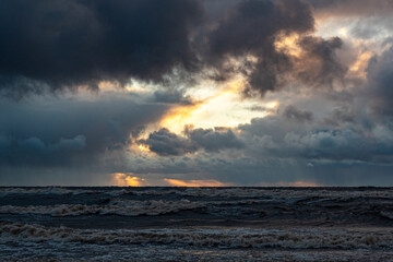 dramatic storm in the Baltic Sea, large waves crashing against the shore, blurred, unclear contours, rocky shore of Vidzeme