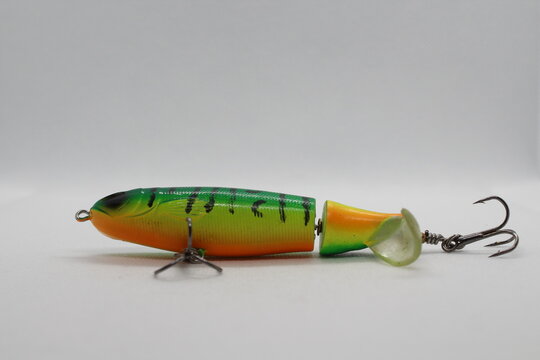Green whopper plopper fishing lure isolated on a white background. Green wobbler popper flopper lure. Topwater fishing lure wobbler
