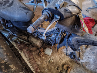 Obraz premium Photo of old and broken motorcycle in garage. Selective focus. 