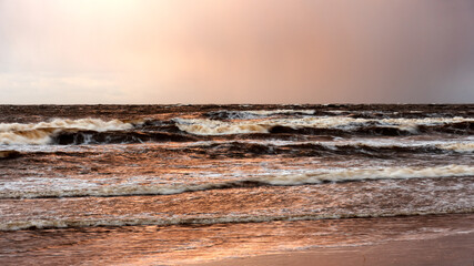 dramatic storm in the Baltic Sea, large waves crashing against the shore, blurred, unclear...