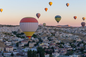 Hot air balloons take off at dawn in Cappadocia