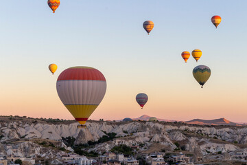 Hot air balloons take off at dawn in Cappadocia
