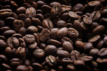Coffee beans background. Low key. Close up.
