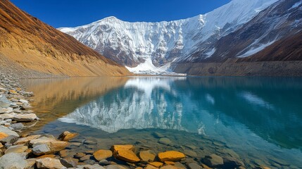 A serene mountain landscape with misty peaks reflecting in a tranquil lake at sunrise offering a calming and inspiring natural scenery background