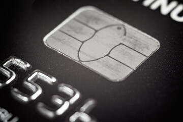 Close-up of a bank card chip demonstrating contactless payment