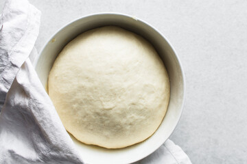 Overhead view of proofed challah bread dough, process of making challah