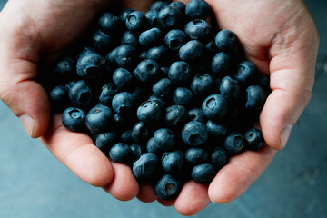 person  holds handful of berries