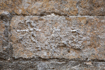 Obraz premium This is a closeup view of a brick wall featuring a cross thats carved into it