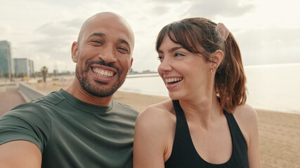 Portrait of an active happy fit couple of athletes taking selfie during morning workout