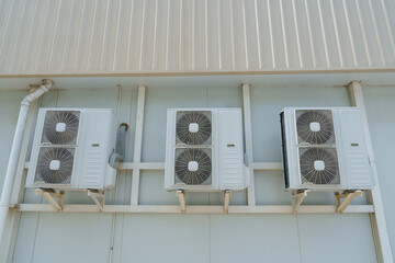 Air compressor or air condenser unit located on support outside building to heat released...