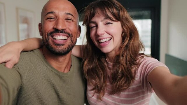 Happy couple make selfie video, smiling and laughing. Love, home, happiness, relationship, social media, new house, family, together.