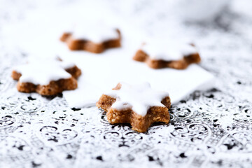 Christmas cookies (cinnamon stars) on bright background. Close up.