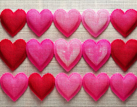 Rows of pink and red hearts in counted cross stitch AI